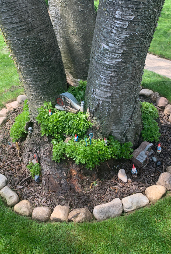 fairy garden at the base of a tree