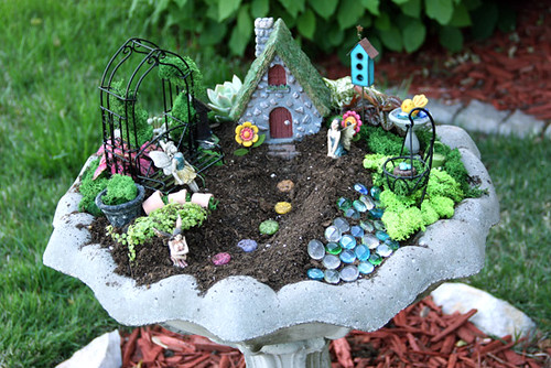 outdoor fairy garden in a birth bath