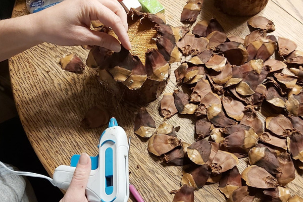 making a fairy house roof from pinecones