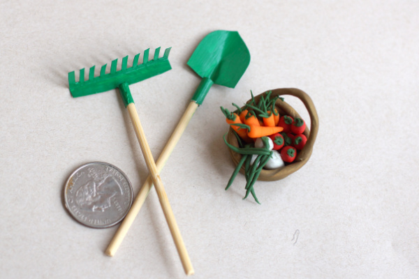 hand made mini garden tools and polymer clay vegetables with a quarter for perspective