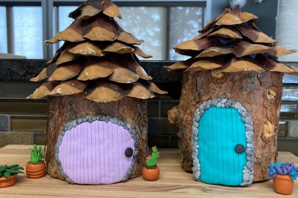 simple fairy house from log and pinecone