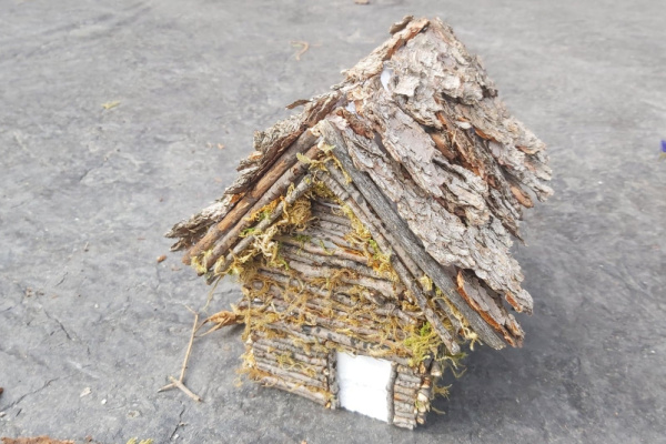 log cabin fairy house with spruce bark roof