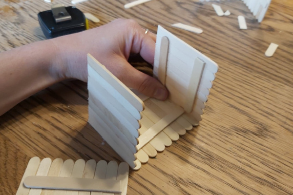 making a popsicle stick house for a fairy garden