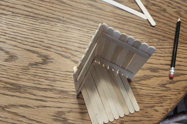 measuring the walls of the popsicle stick house