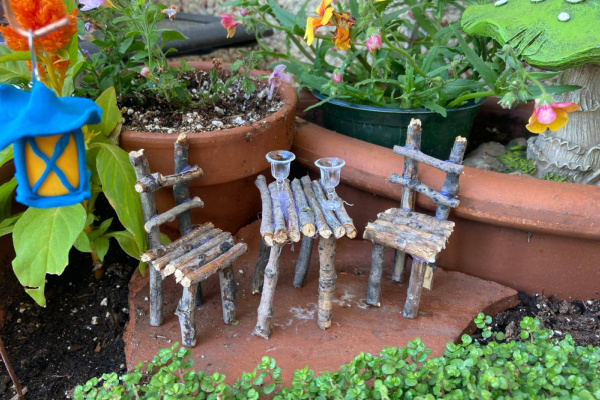 twig fairy furniture in broken pot garden