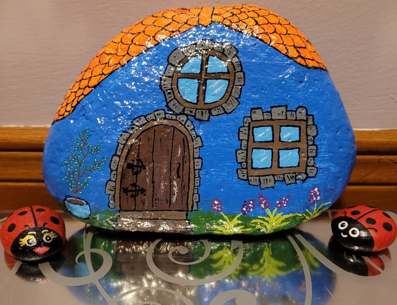 blue fairy house painted on stone