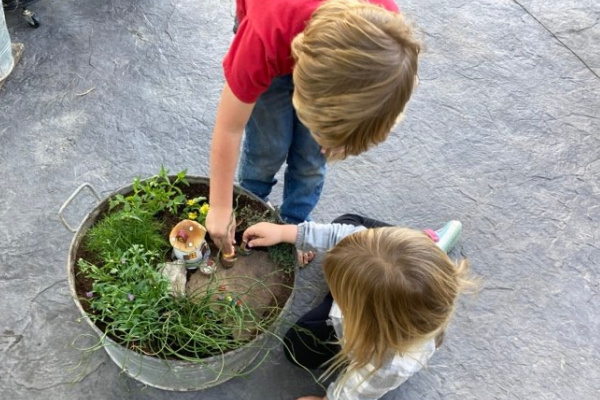 kids playing with a gnome garden