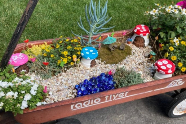 fairy garden in a wagon with toadstool fairy houses